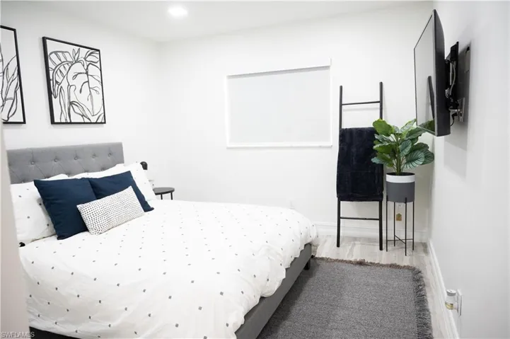 Bedroom with wood finished floors and recessed lighting