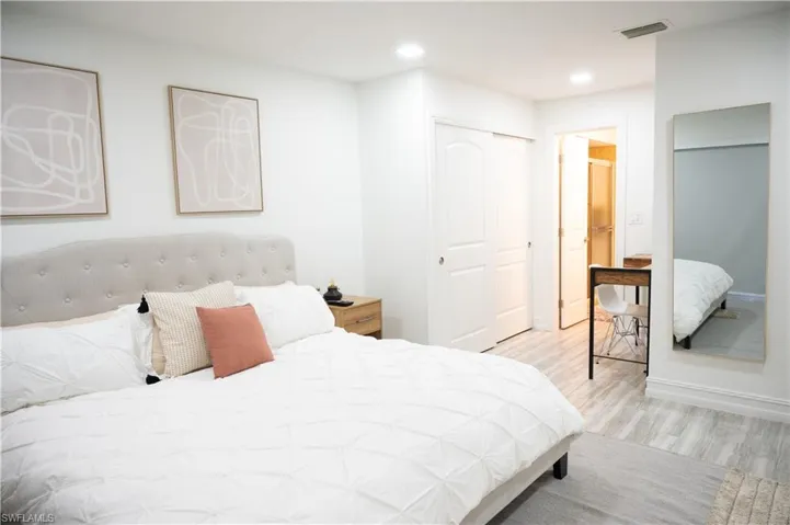 Bedroom featuring light wood finished floors, a closet, and recessed lighting