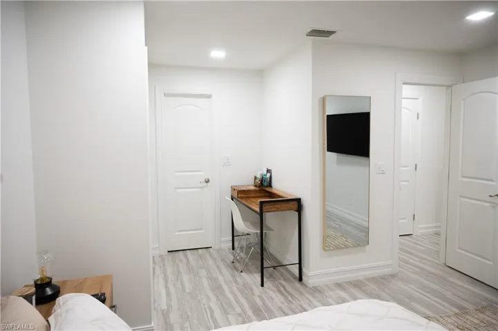 Bedroom with light wood-style flooring and recessed lighting