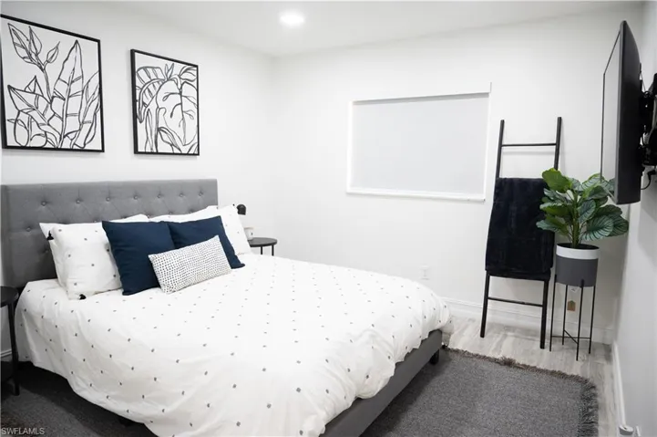 Bedroom featuring wood finished floors and recessed lighting