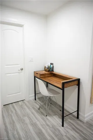 Home office featuring light wood-style floors and baseboards