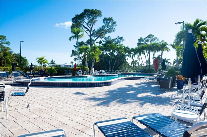 Community pool with a patio