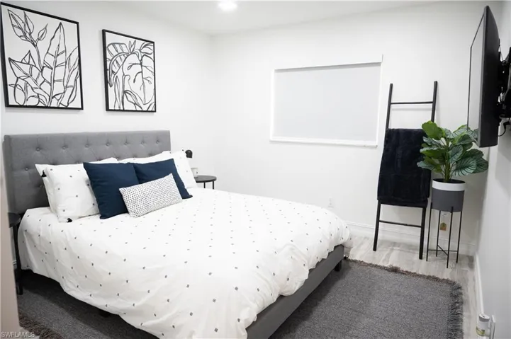 Bedroom with wood finished floors and recessed lighting