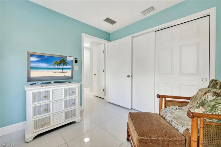 Sitting room featuring light tile patterned floors and baseboards
