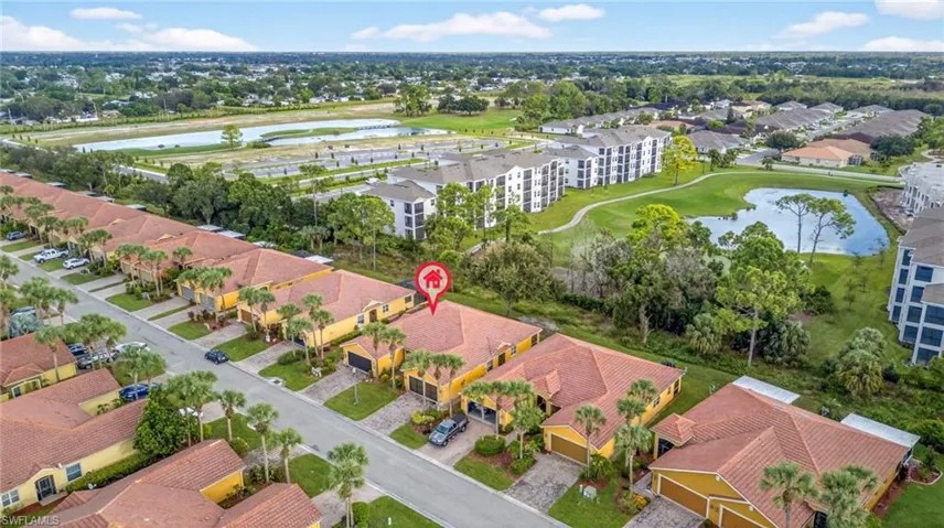 Aerial perspective of suburban area featuring a large body of water