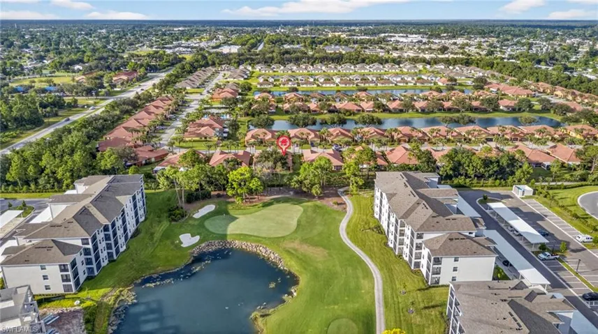 Aerial view of property and surrounding area featuring a large body of water and nearby suburban area