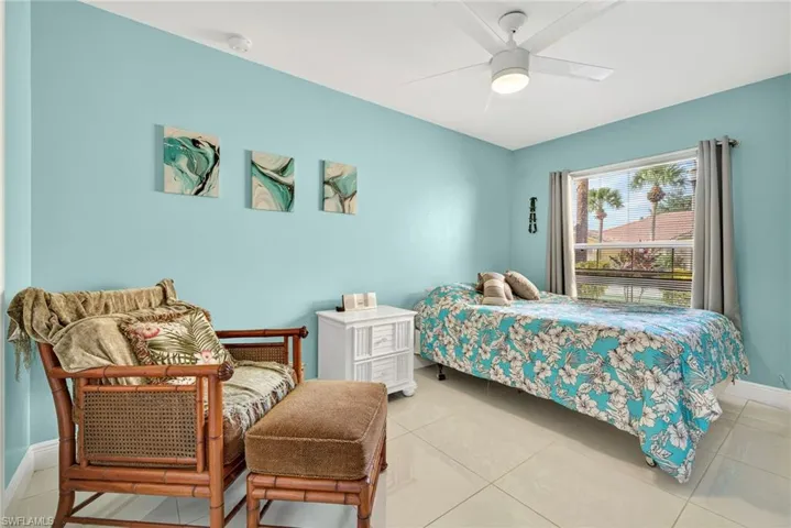 Bedroom featuring light tile patterned flooring and ceiling fan