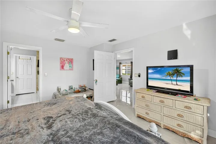 Bedroom featuring light tile patterned floors and a ceiling fan