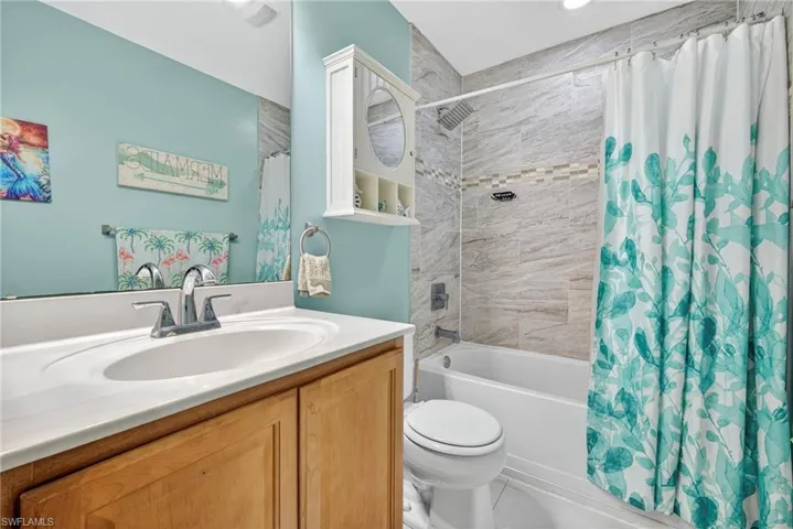 Full bath with vanity and shower / bath combo with shower curtain