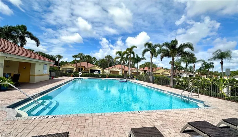 Community pool with a residential view and a patio