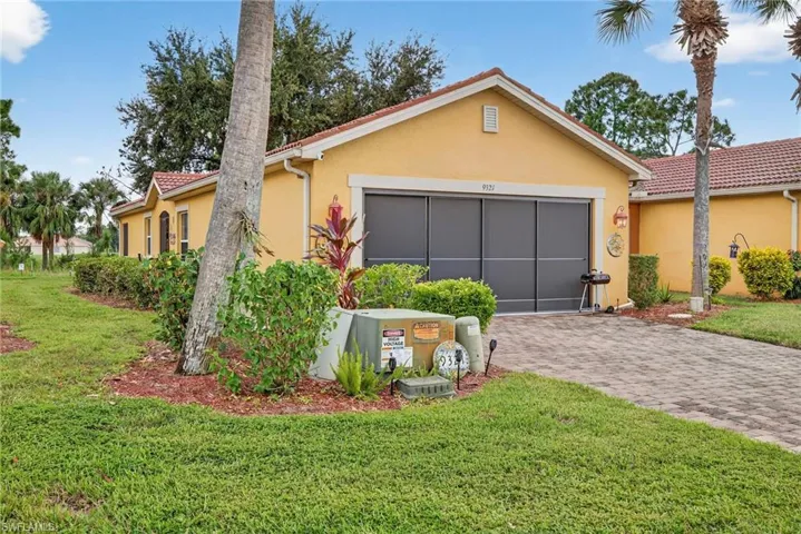 View of front of house featuring stucco siding, a front lawn, decorative driveway, a garage, and a tiled roof