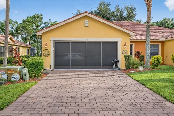 Single story home with stucco siding, decorative driveway, a front yard, a garage, and a tiled roof