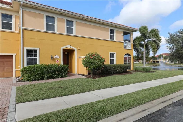 View of front of property with a front yard and a garage