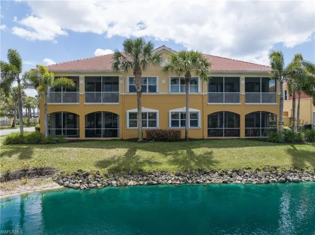 Rear view of house featuring a yard and a balcony