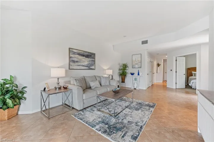 Living area with light tile patterned floors and baseboards