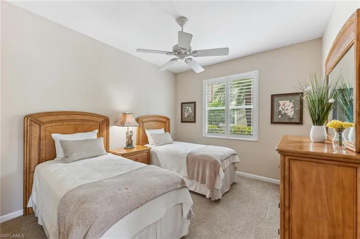 Bedroom featuring light colored carpet and a ceiling fan