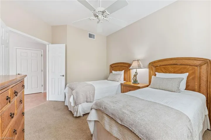 Bedroom featuring light colored carpet and ceiling fan