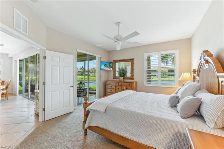 Bedroom featuring access to outside, light tile patterned floors, and ceiling fan