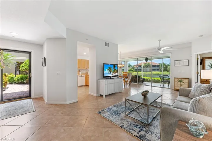 Living area with light tile patterned flooring and a ceiling fan