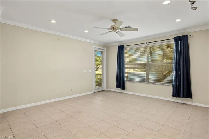 Unfurnished room featuring ornamental molding, ceiling fan, and light tile patterned floors