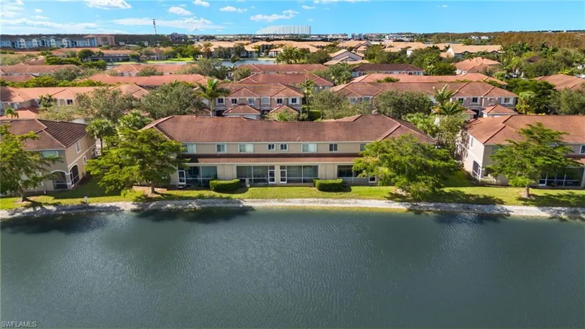 Birds eye view of property with a water view