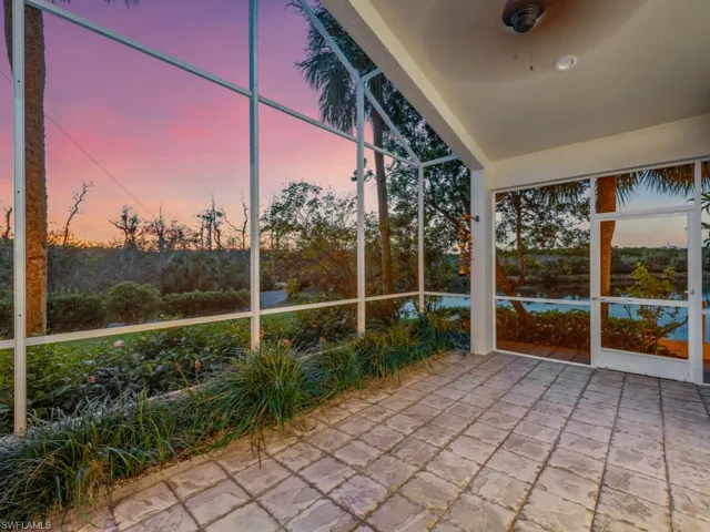 Unfurnished sunroom with ceiling fan