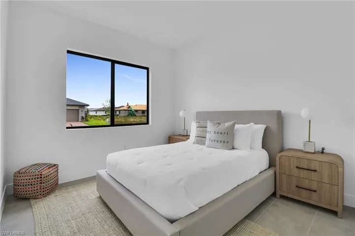 Bedroom featuring baseboards and light tile patterned floors