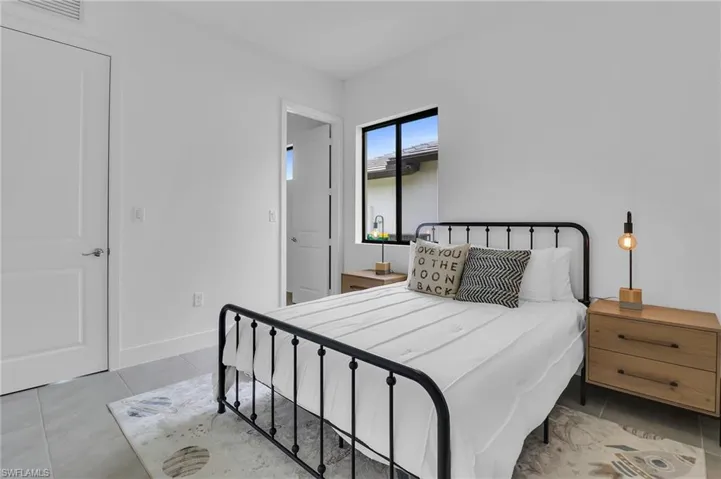 Bedroom featuring tile patterned floors and baseboards