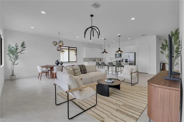 Living area featuring recessed lighting, a chandelier, and light tile patterned floors
