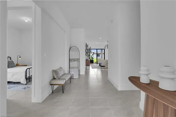 Corridor with light tile patterned floors and baseboards