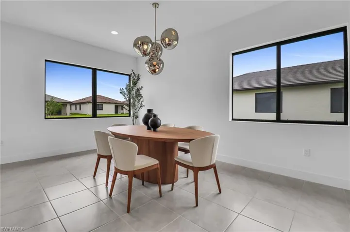 Dining space with a chandelier, recessed lighting, and light tile patterned floors