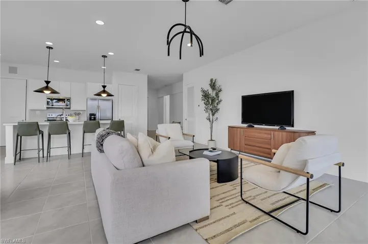 Living room featuring recessed lighting and light tile patterned flooring