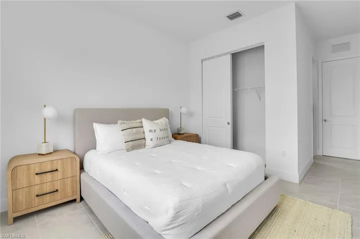 Bedroom featuring light tile patterned floors and a closet