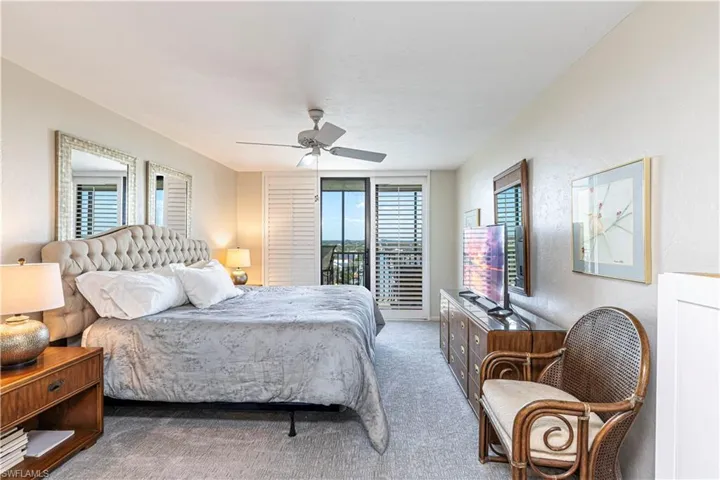 Carpeted bedroom featuring access to outside and a ceiling fan