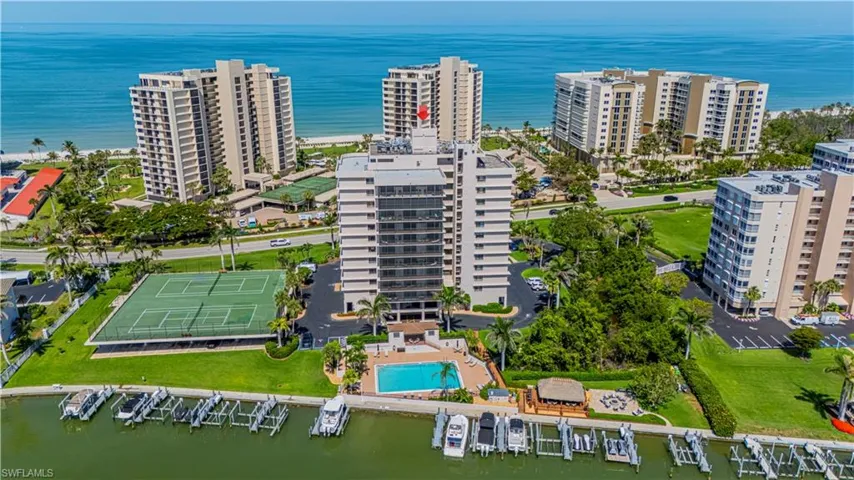 View of urban area featuring a nearby body of water, apartment complex, and a pool area