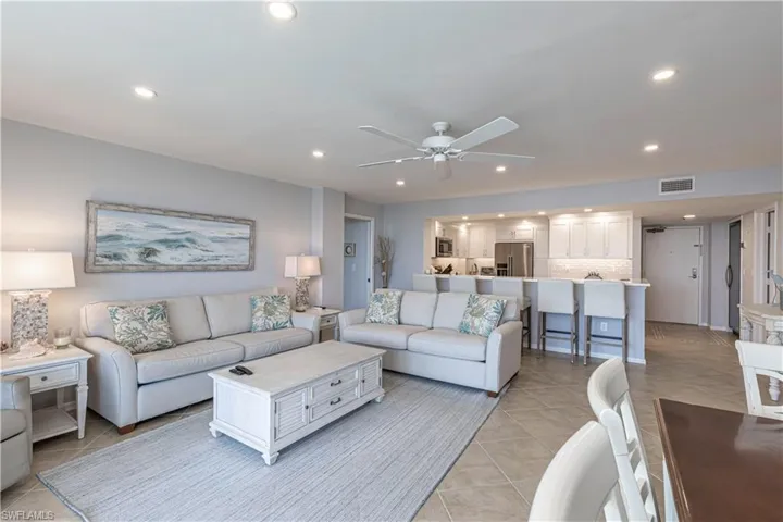 Living area featuring ceiling fan, recessed lighting, and light tile patterned floors
