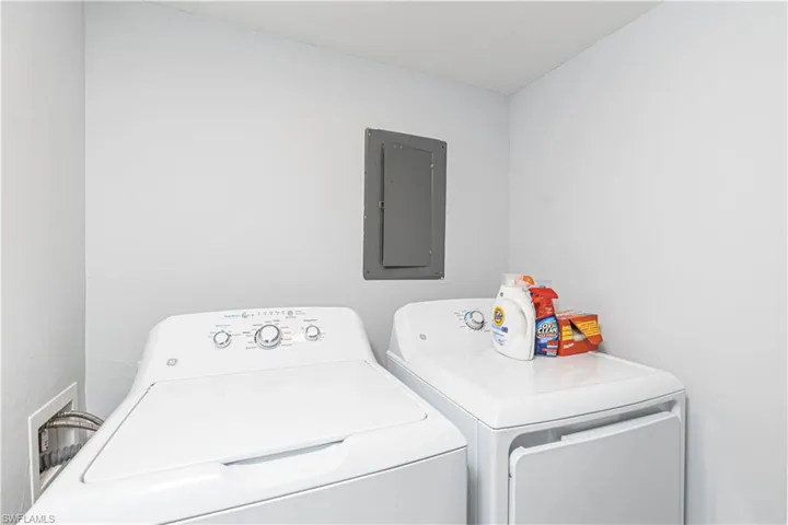 Laundry area with electric panel and washing machine and clothes dryer