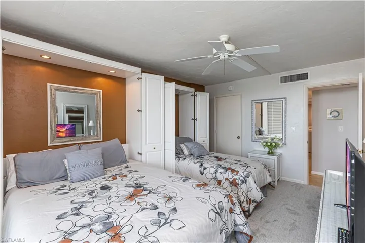 Carpeted bedroom featuring recessed lighting, a ceiling fan, and baseboards