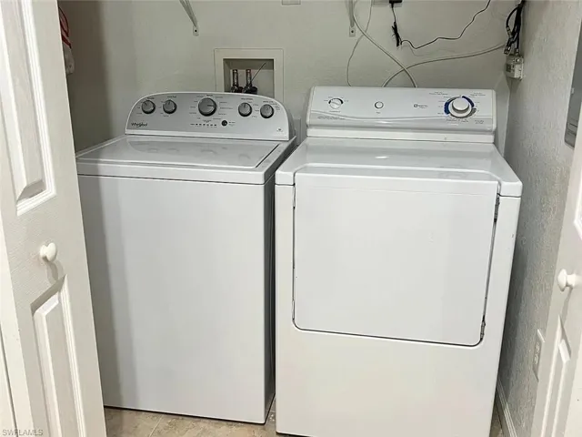 Laundry room with washing machine and clothes dryer