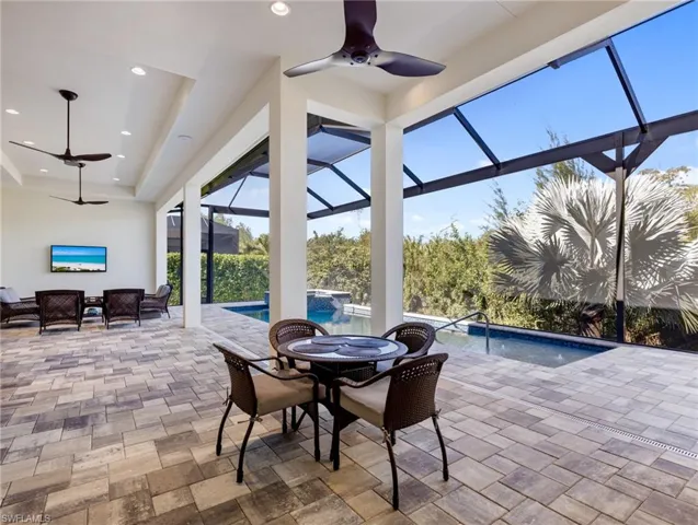 View of patio with a ceiling fan, outdoor dining area, a lanai, and a sunroom