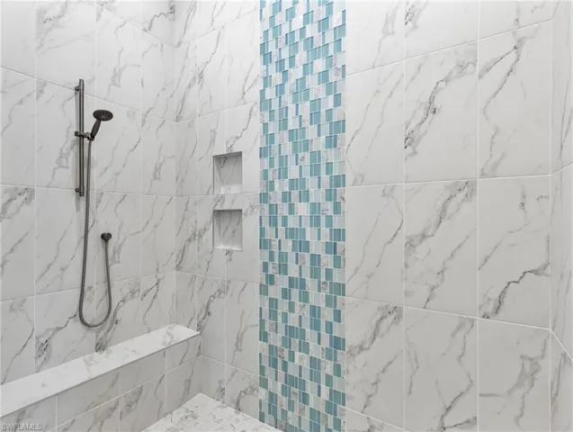 Full bath featuring a marble finish shower