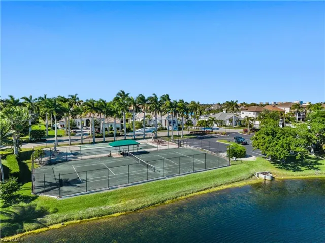 View of tennis court featuring a water view