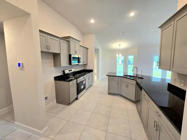 Kitchen with sink, appliances with stainless steel finishes, and gray cabinetry