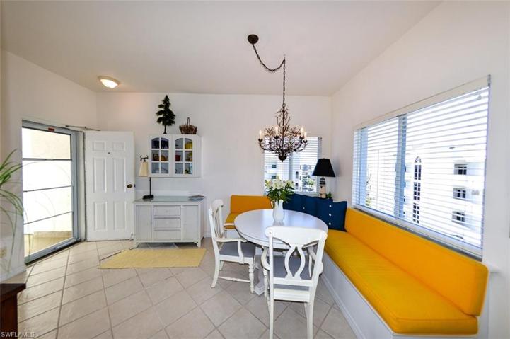 UNIT ENTRANCE.  BUILT-IN CORNER BANQUETTE W/BENCH STORAGE.