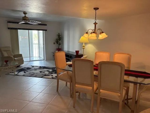 Dining area with light tile patterned floors and ceiling fan