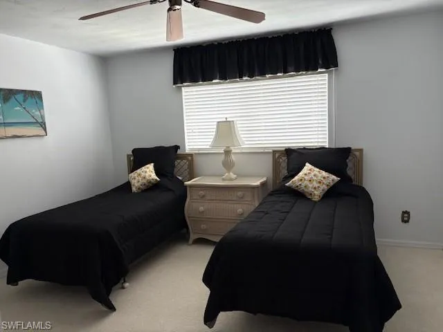 Bedroom featuring carpet, ceiling fan, and a textured ceiling