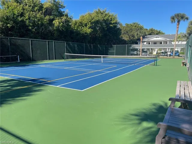View of tennis court with community basketball court