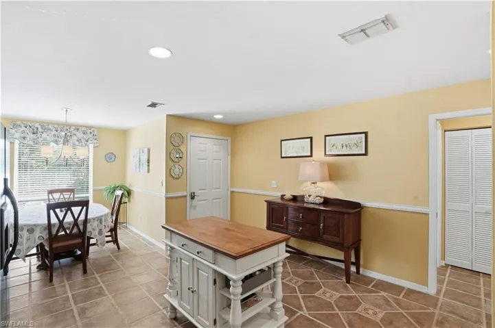 Kitchen featuring white cabinets, dishwasher, black range with electric stovetop, and recessed lighting