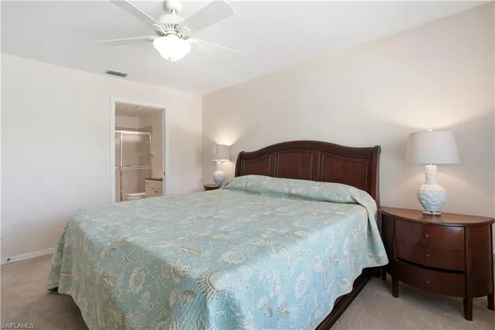 Bedroom featuring light colored carpet and ceiling fan