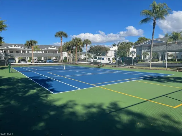 View of tennis court with community basketball court and a residential view